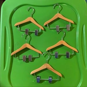 Set of 5 Mini wooden hangers with adjustable clips.